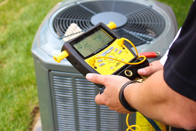 Air condition being service by a repair person.