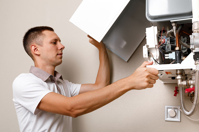 Technician inspecting a boiler.