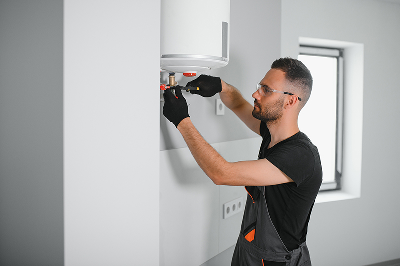 Plumbing inspecting boiler pipes.