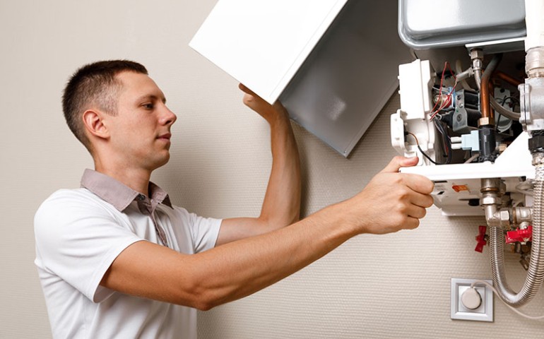 Technician inspecting a boiler.