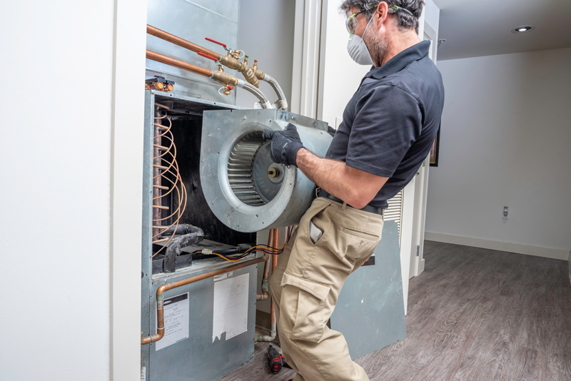 HVAC technician fixing a hvac unit in a home.